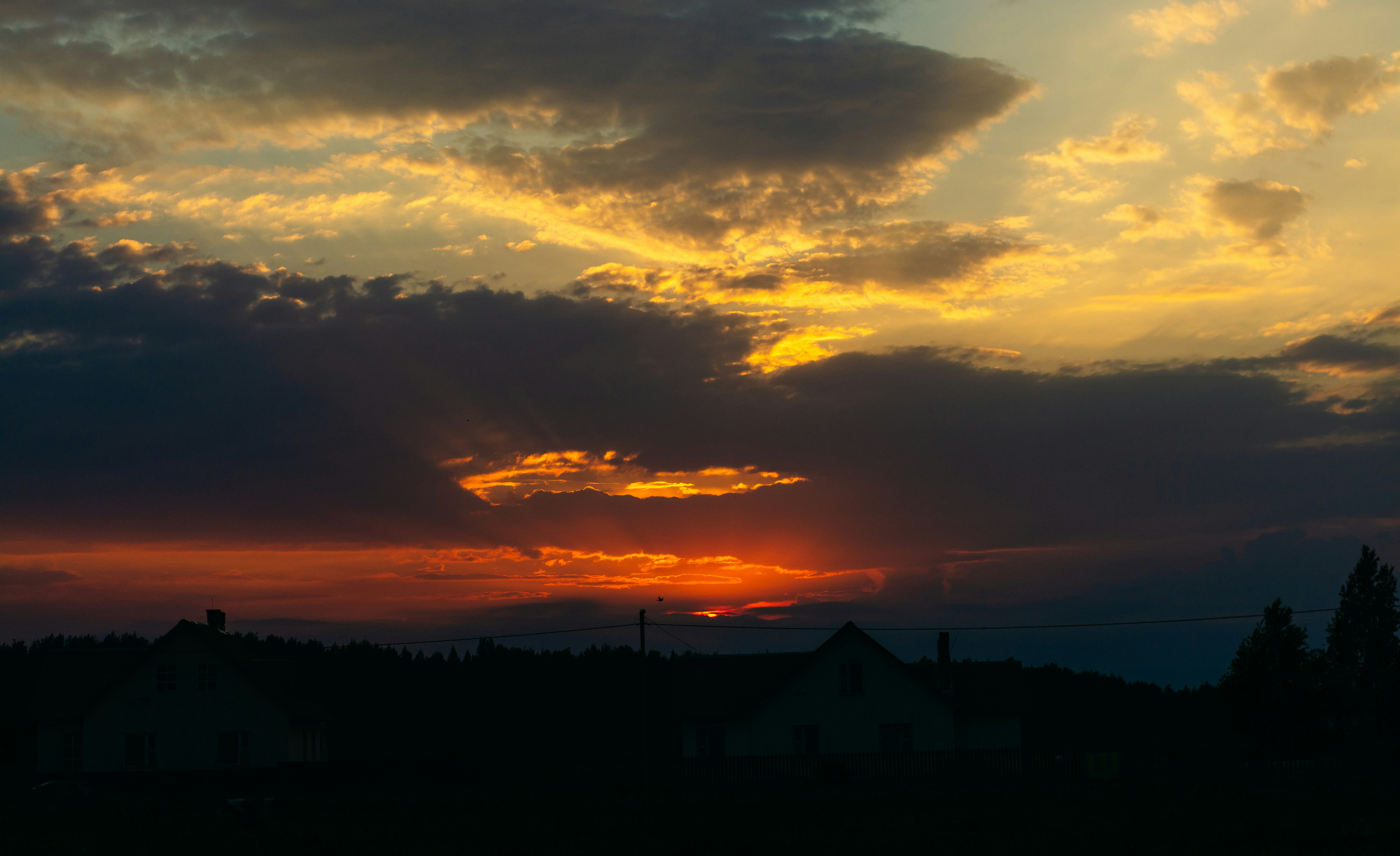 silhouette of mountain under orange and yellow skies